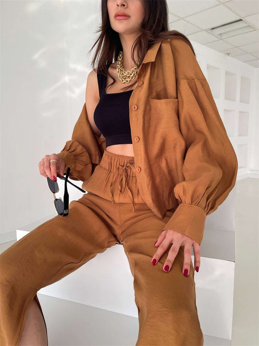 Woman wearing a brown outfit with a black top in an indoor setting