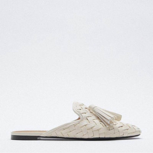 White woven loafer with tassels on a white background