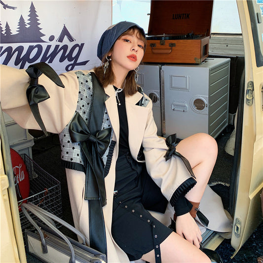 Woman sitting inside a van with camping gear and a 'camping' sign in the background by millivan