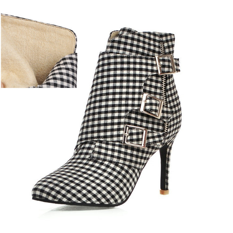 Black and white checkered boot with buckles on a white background