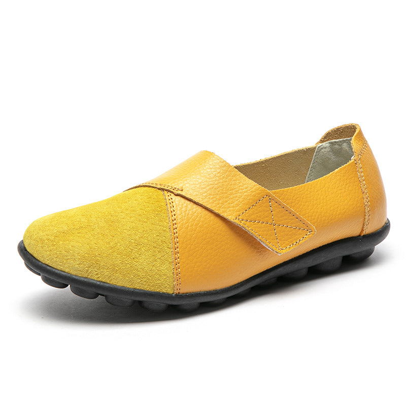 Yellow slip-on shoe with a black sole on a white background