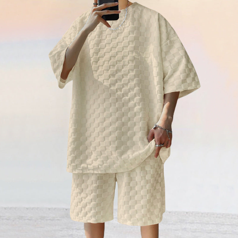 Person wearing a textured beige outfit with a matching jacket and shorts on a light background