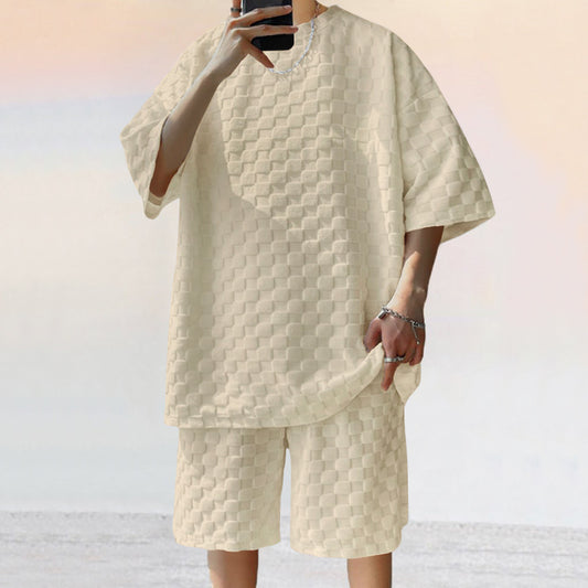 Person wearing a textured beige outfit with a matching jacket and shorts on a light background
