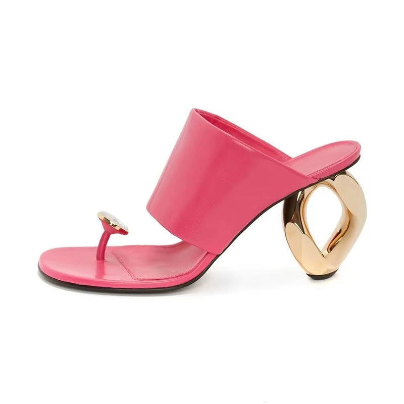 Pink sandal with a gold heel on a white background