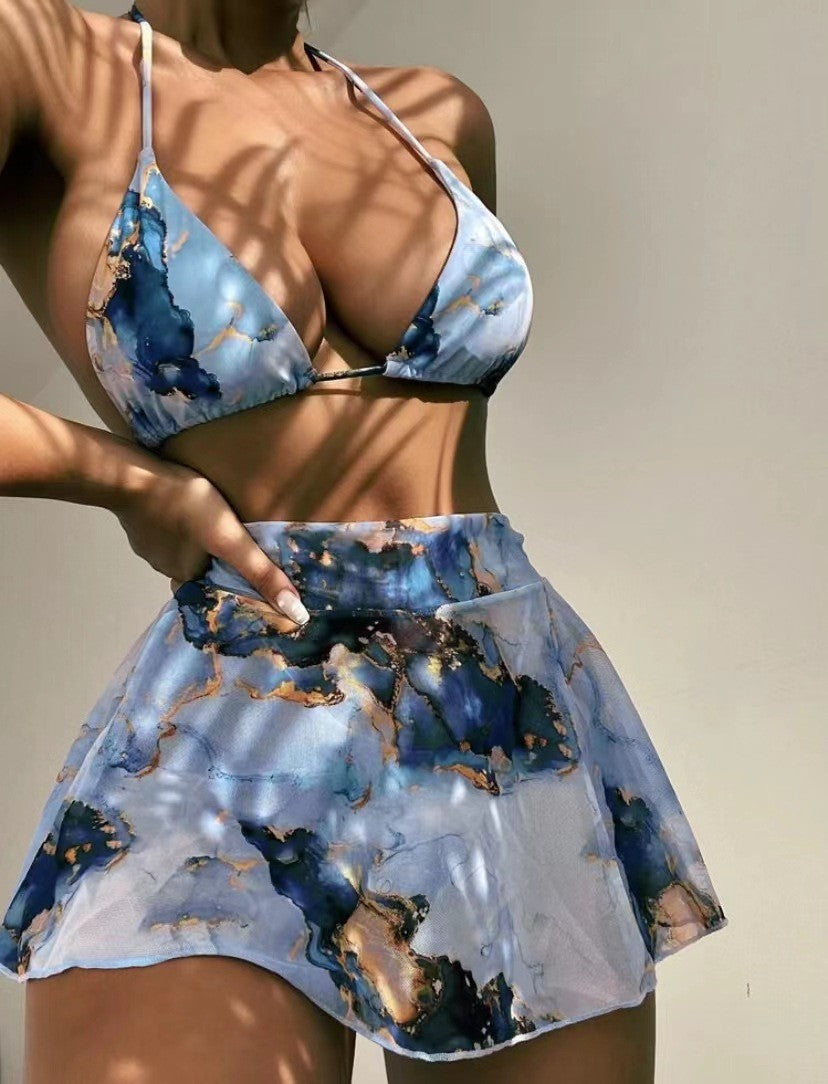 Woman wearing a blue and white patterned bikini with a blurred background