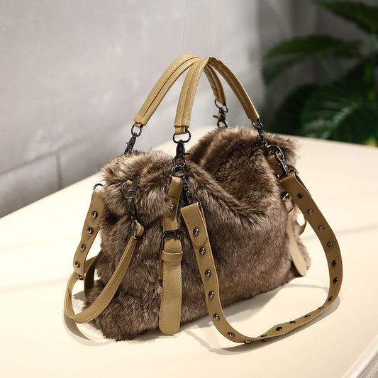 Brown fur handbag with beige straps on a light surface