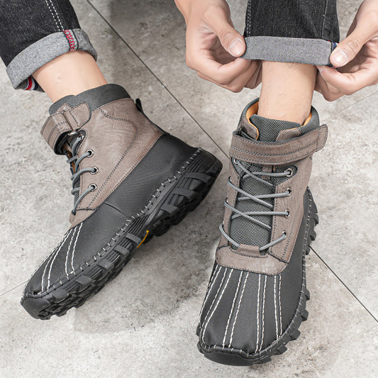 Person wearing gray winter boots on a concrete floor