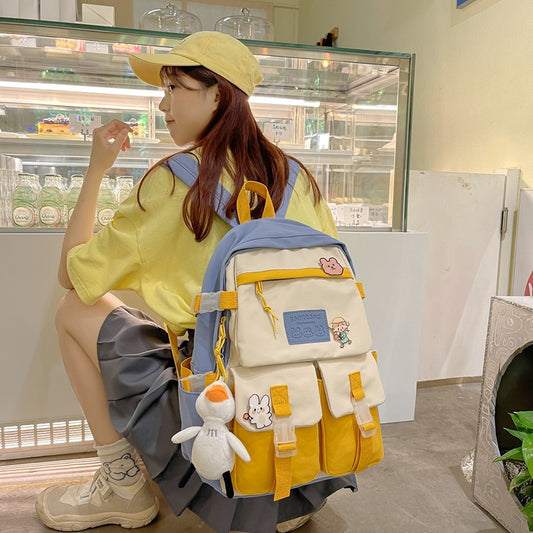 Person wearing a yellow cap and backpack with cartoon characters in a store setting