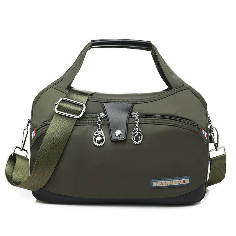 Green handbag with black accents on a white background