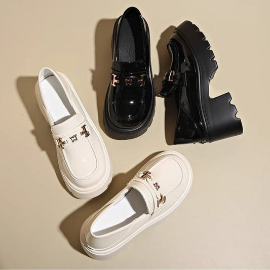 Two pairs of shoes, one white and one black, on a beige background.