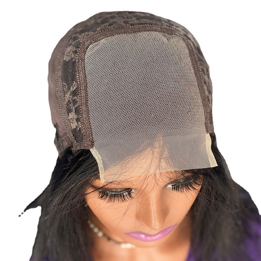 Close-up of a wig with lace front and mesh cap on a white background