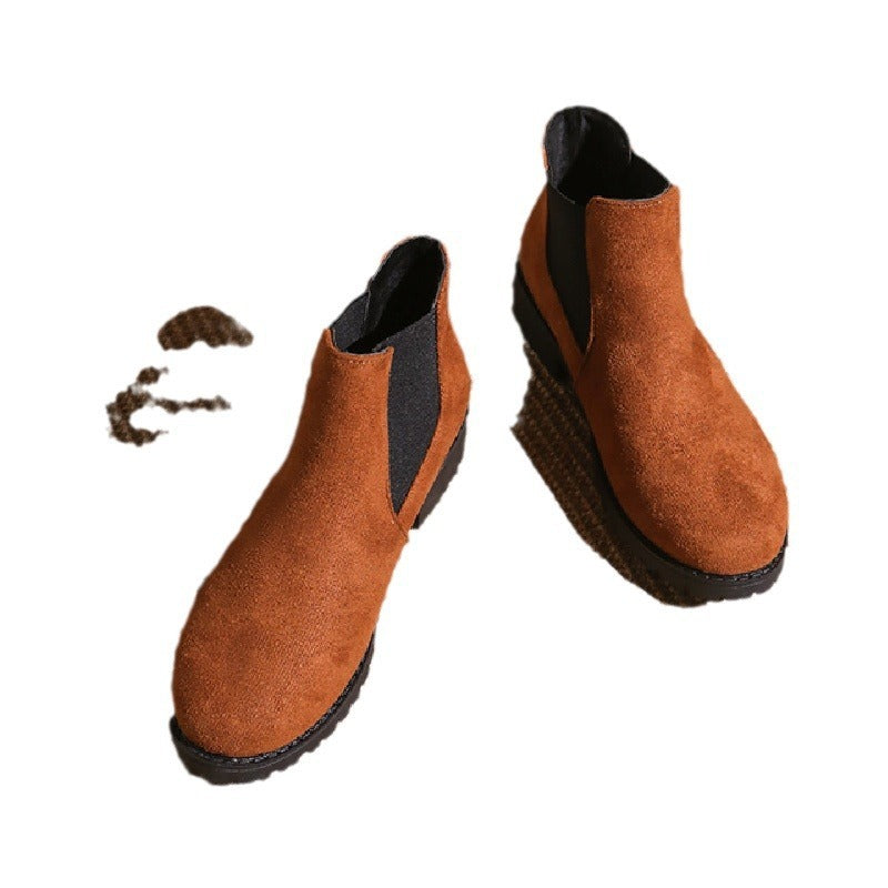 Pair of brown Chelsea boots on a white background
