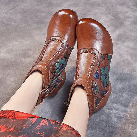 Brown leather shoes with floral patterns on a gray background