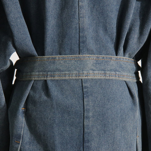Close-up of a blue denim dress with a belt