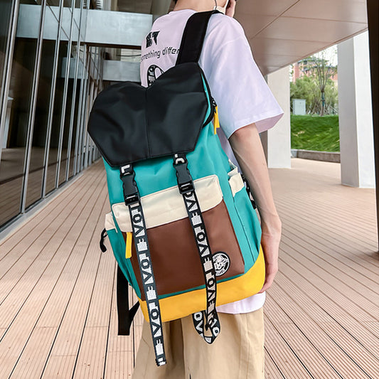 Person wearing a colorful backpack with visible branding on a wooden deck.