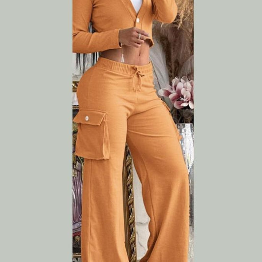 Person wearing a mustard yellow outfit with wide-leg pants and a matching cardigan.
