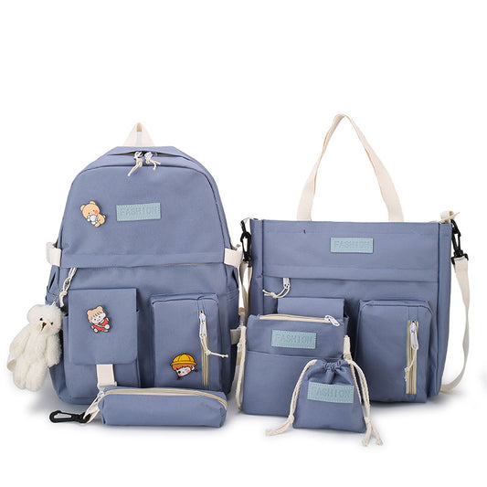 Set of blue bags including a backpack, shoulder bag, and pouches on a white background