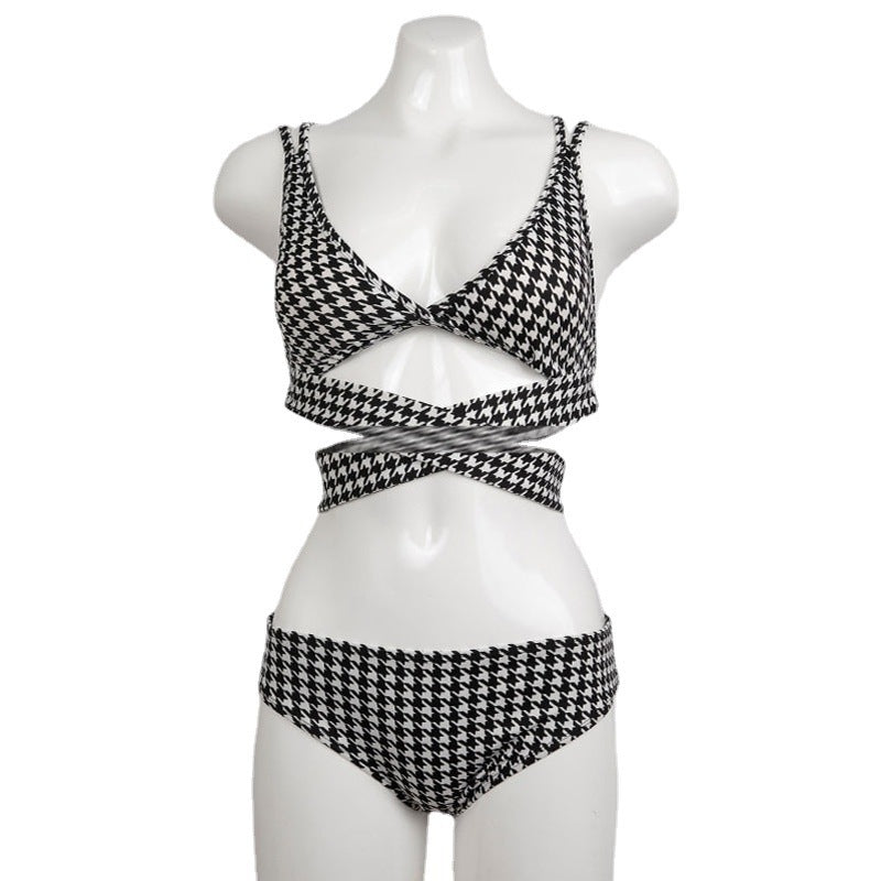 Black and white houndstooth patterned bikini set on a mannequin against a white background