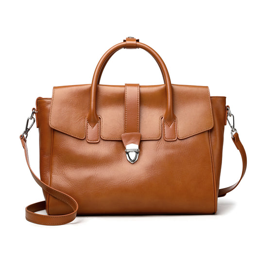 Brown leather handbag with a strap on a white background