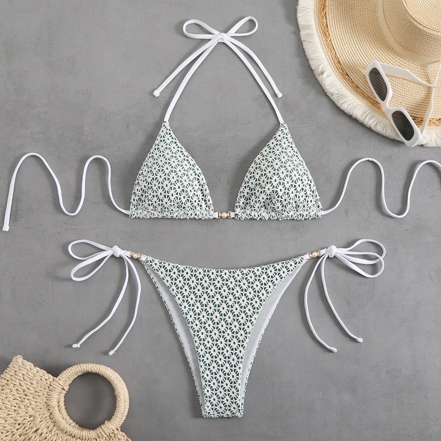 Floral bikini set with matching accessories on a gray background