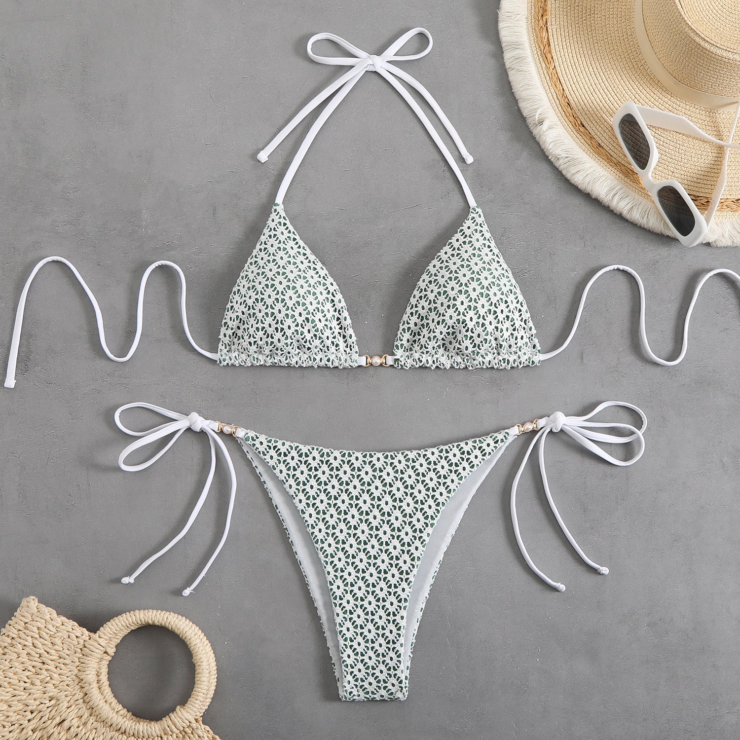 Floral bikini set with matching accessories on a gray background