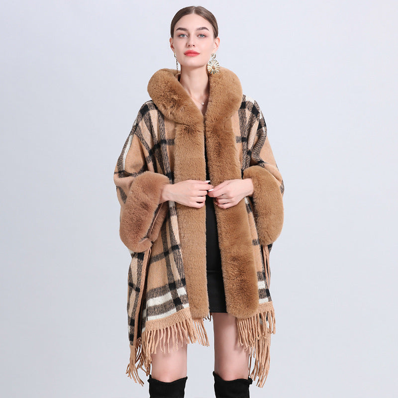 Woman wearing a brown plaid coat with fur trim on a light gray background