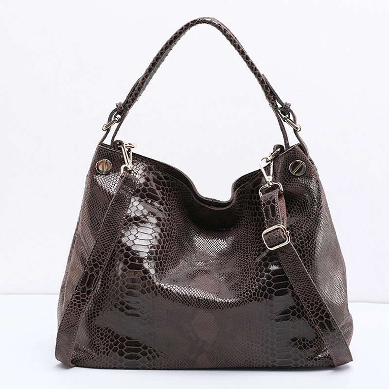 Brown textured handbag with a shoulder strap on a white background