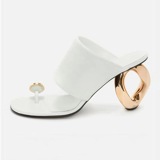 White high-heeled shoe with gold heel on a white background