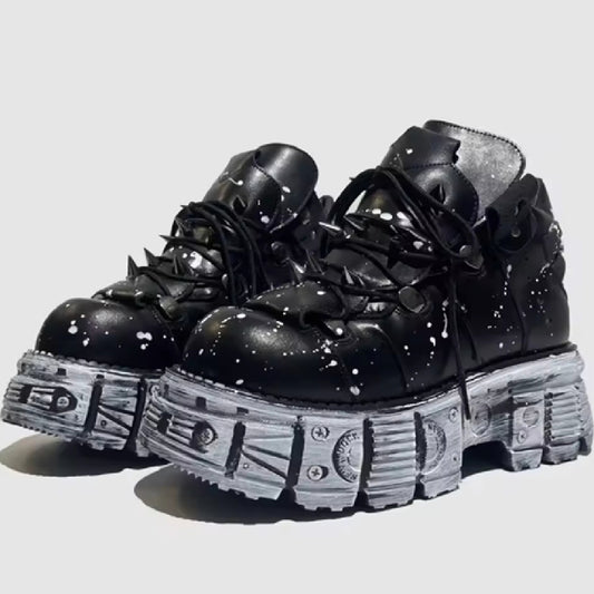 Black platform boots with unique sole design on a light gray background