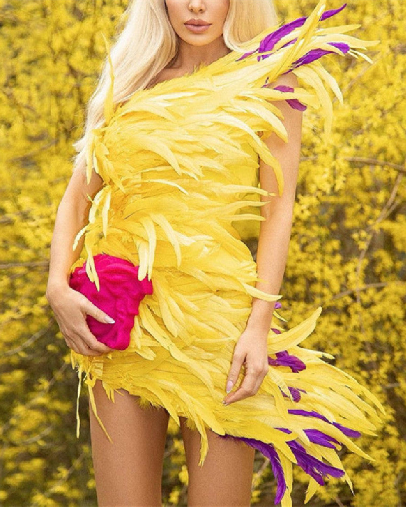 Woman wearing a yellow feathered dress with purple accents against a blurred natural background