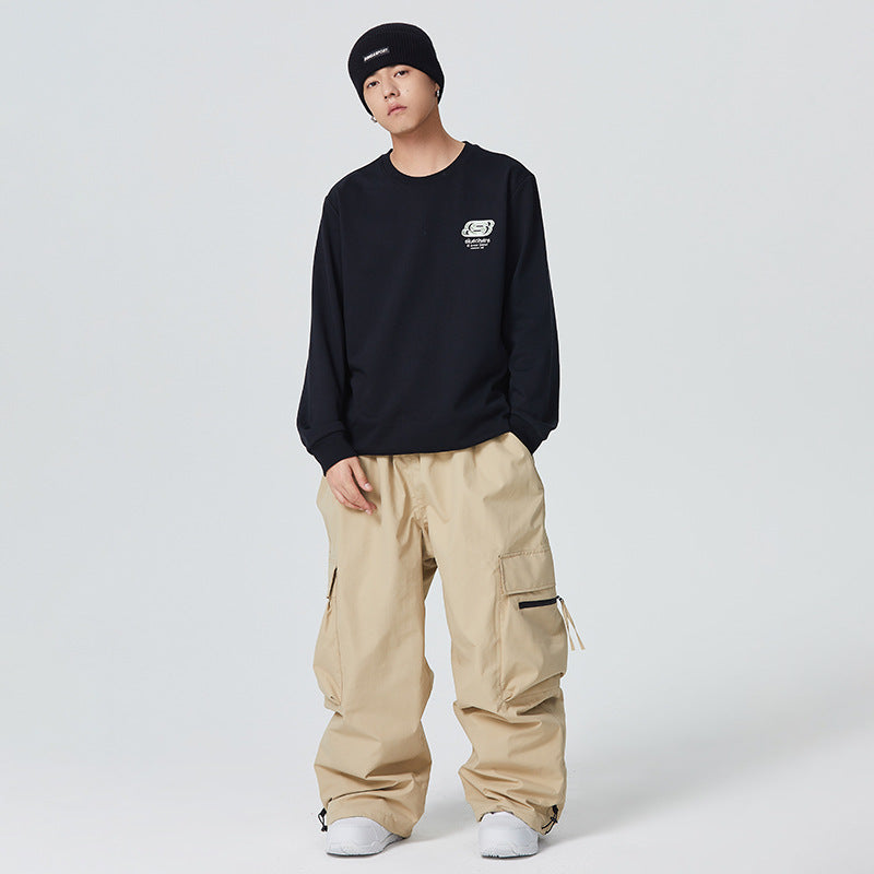 Person wearing a black sweatshirt and beige cargo pants on a white background
