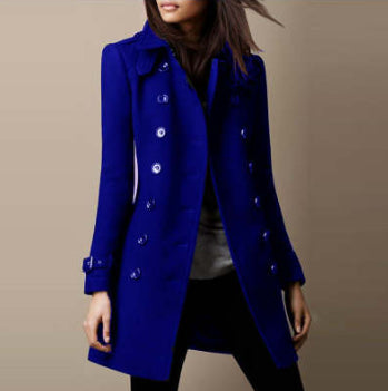 Blue coat worn by a person on a beige background