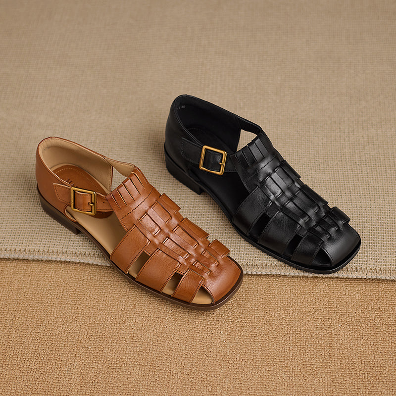 Brown and black sandals with woven design on a beige fabric background