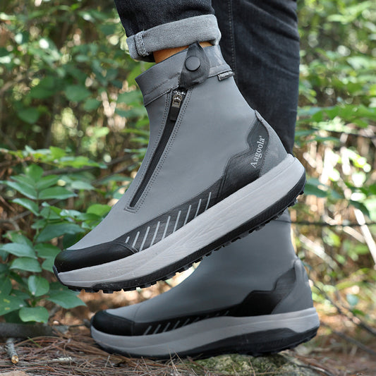 Gray and black winter boots with a blurred natural background
