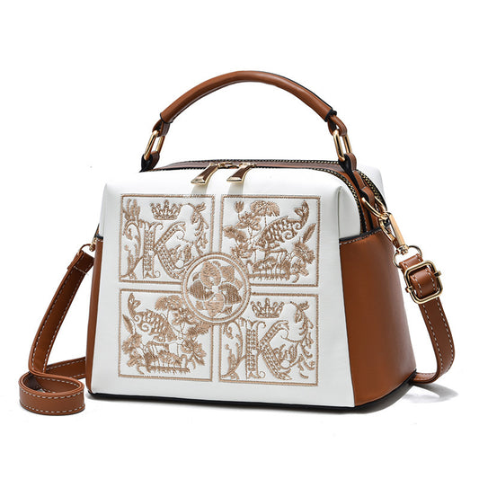 Designer handbag with intricate patterns on a white background