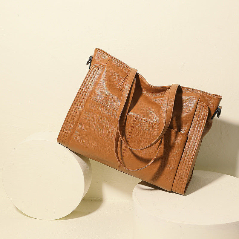 Brown leather handbag on a beige background