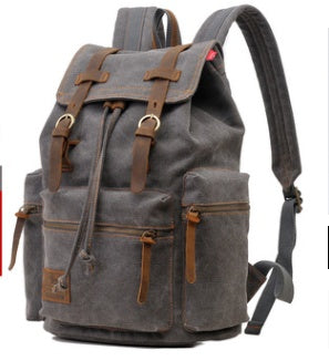 Gray backpack with brown leather straps and accents on a white background