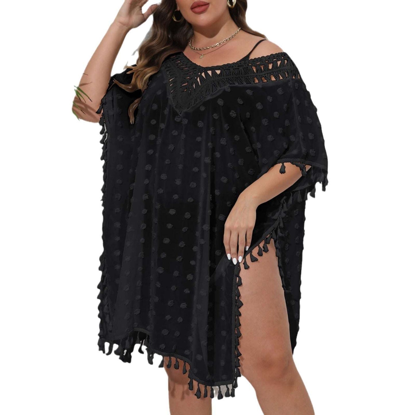 Black polka dot dress with tassels on a white background