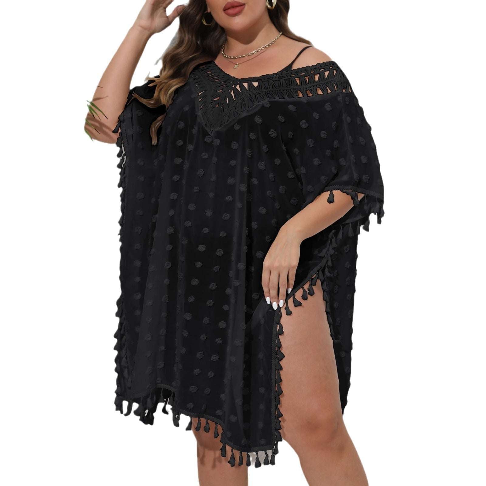 Black polka dot dress with tassels on a white background