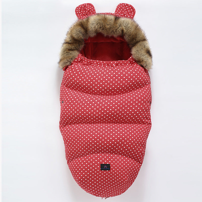 Red polka dot baby sleeping bag with fur hood and red ears on a white background