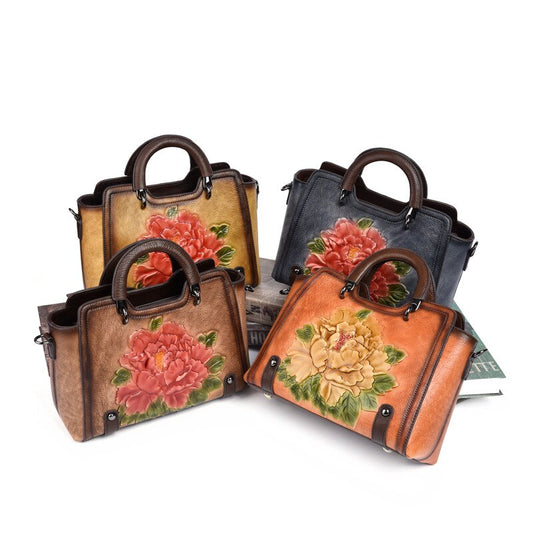 Four handbags with floral designs on a white background