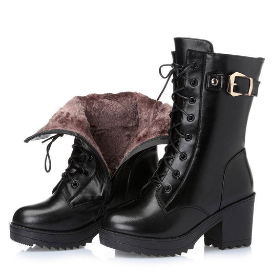Black leather boots with fur lining on a white background