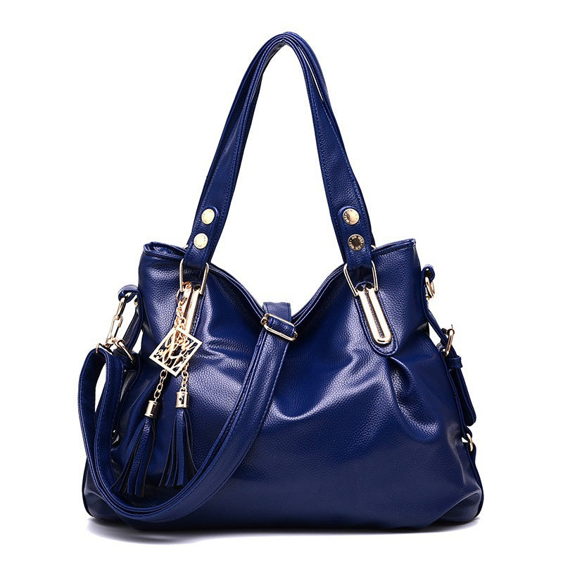 Blue handbag with gold accents on a white background
