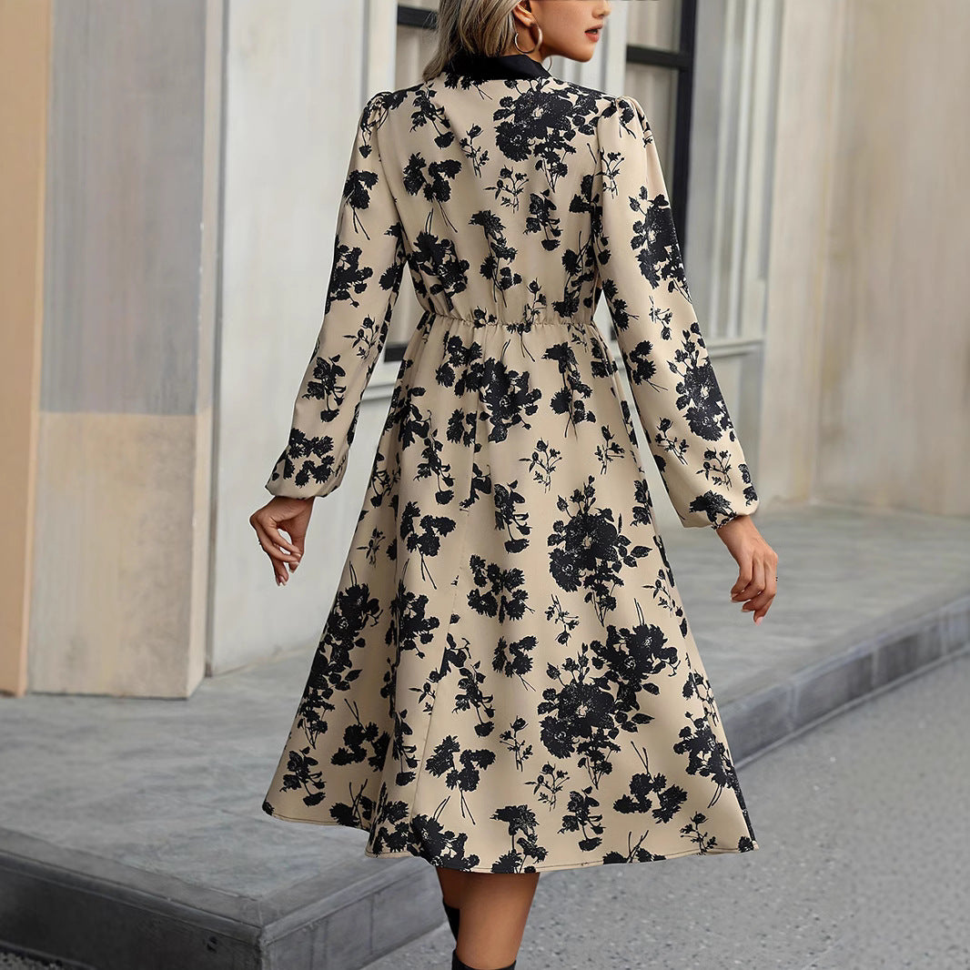 Woman wearing a floral dress walking outdoors.