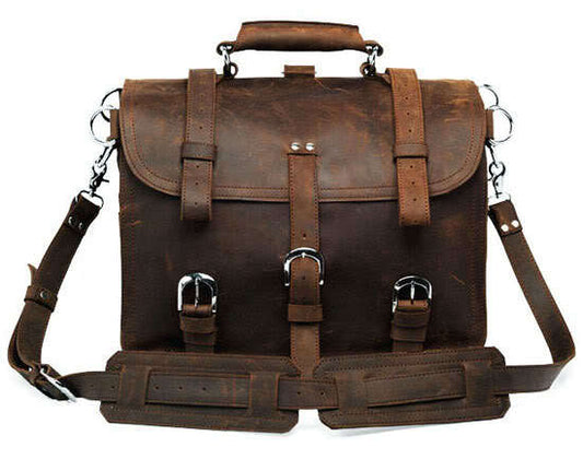 Brown leather satchel bag with multiple straps on a white background