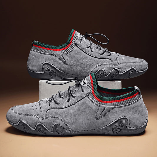 Gray sneakers with green and red accents on a brown background