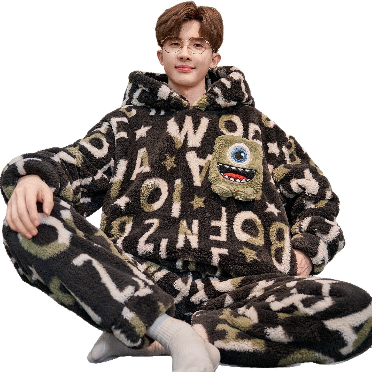 Person wearing a brown fleece onesie with lettering and a cartoon character on a white background