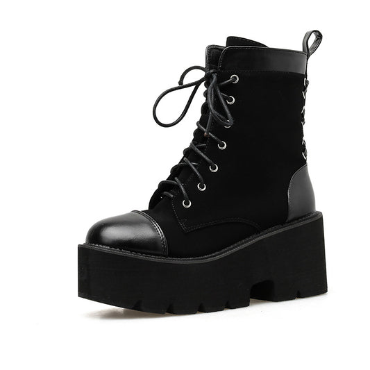 Black platform boot with lace-up design on a white background