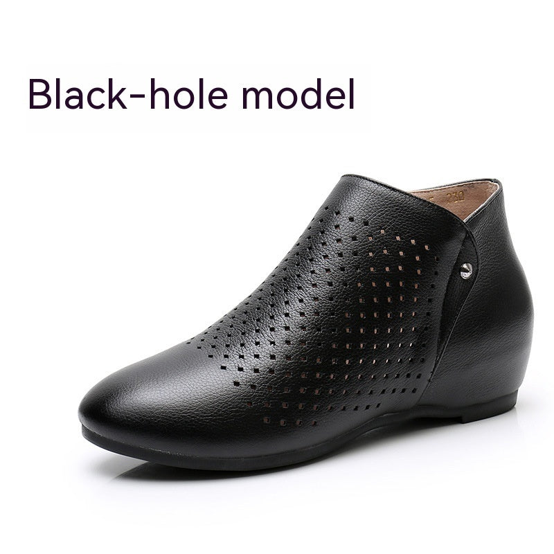 Black leather shoe with perforated design on a white background