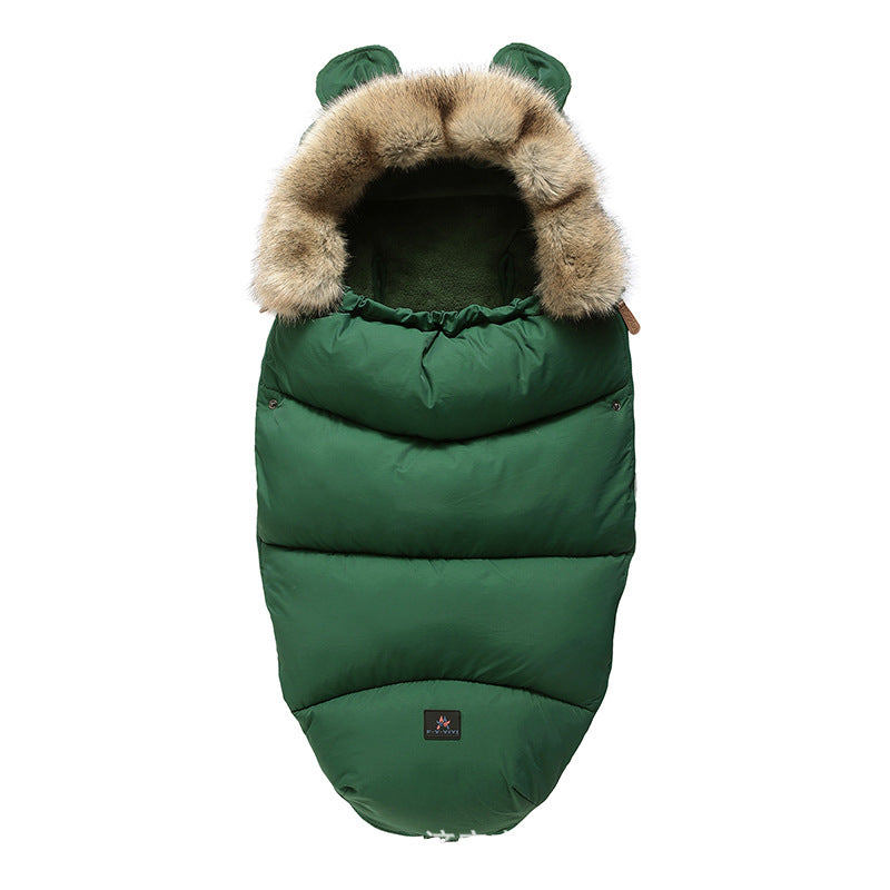 Green baby sleeping bag with fur hood on a white background